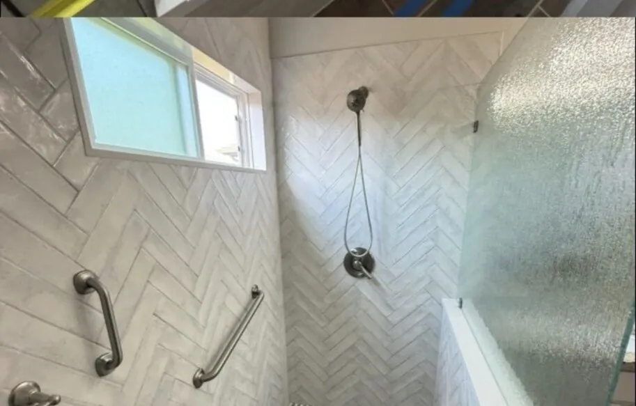 Finished walk-in shower with herringbone wall tile
