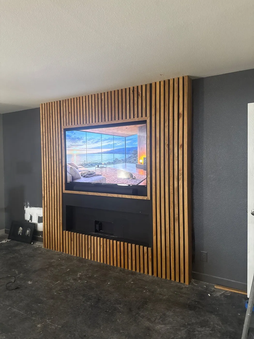 Slat-wood media wall from an angle with the TV inset flush