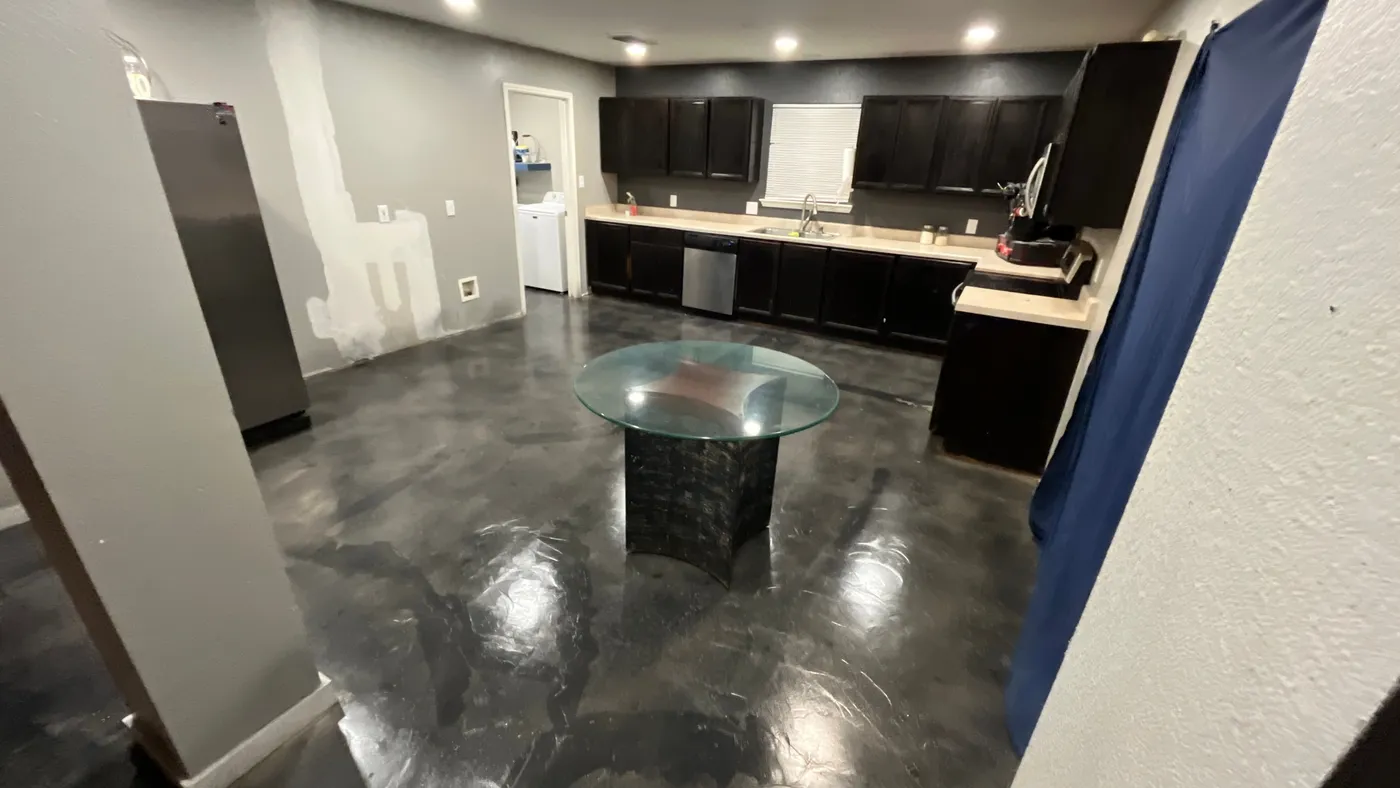 Epoxy floor in the dining area with a glass table