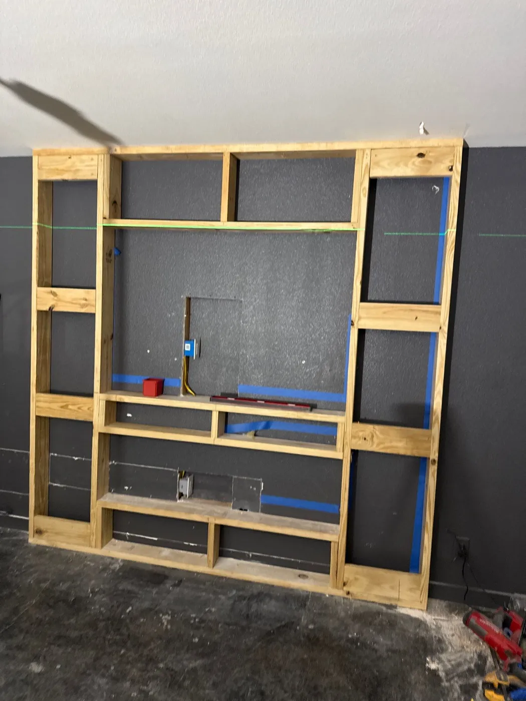 The media wall framed out before the slat cladding went on