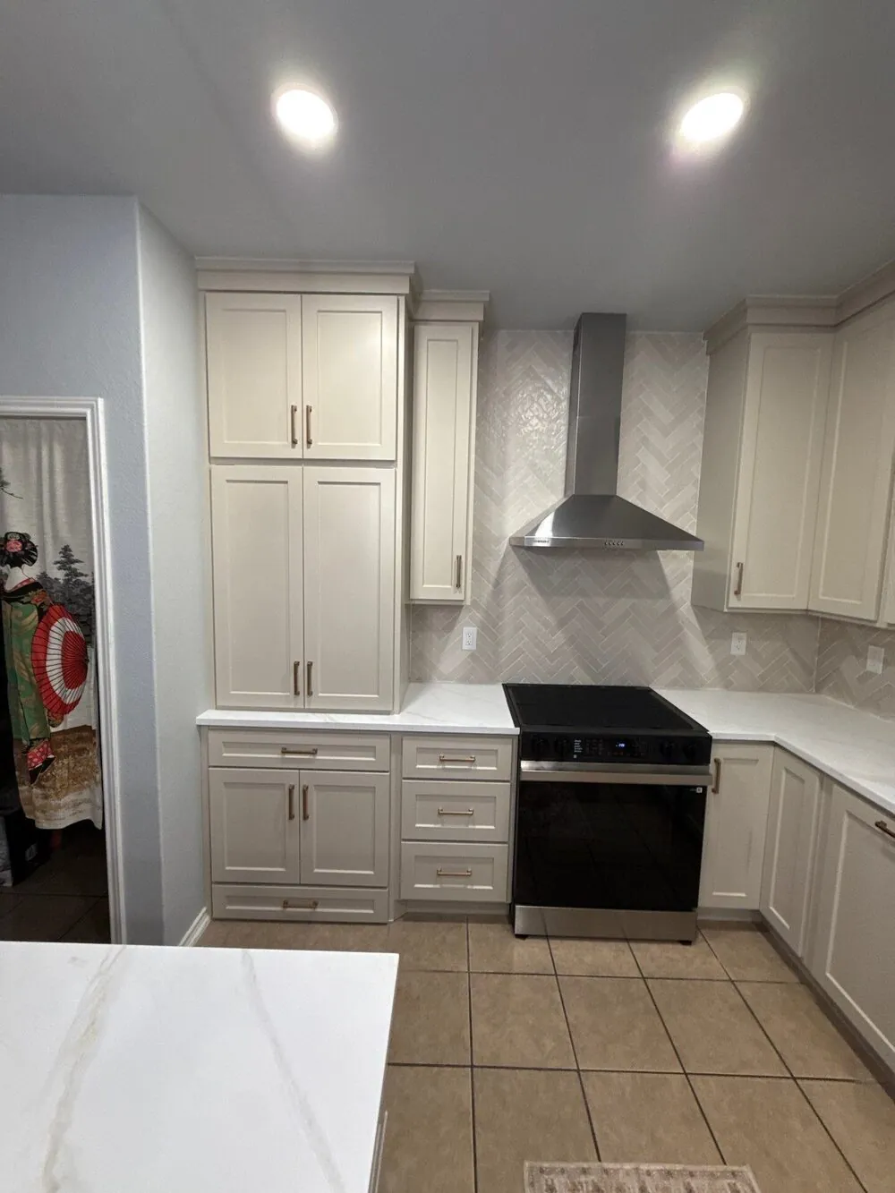 Cabinet run with the range, vent hood and quartz counter