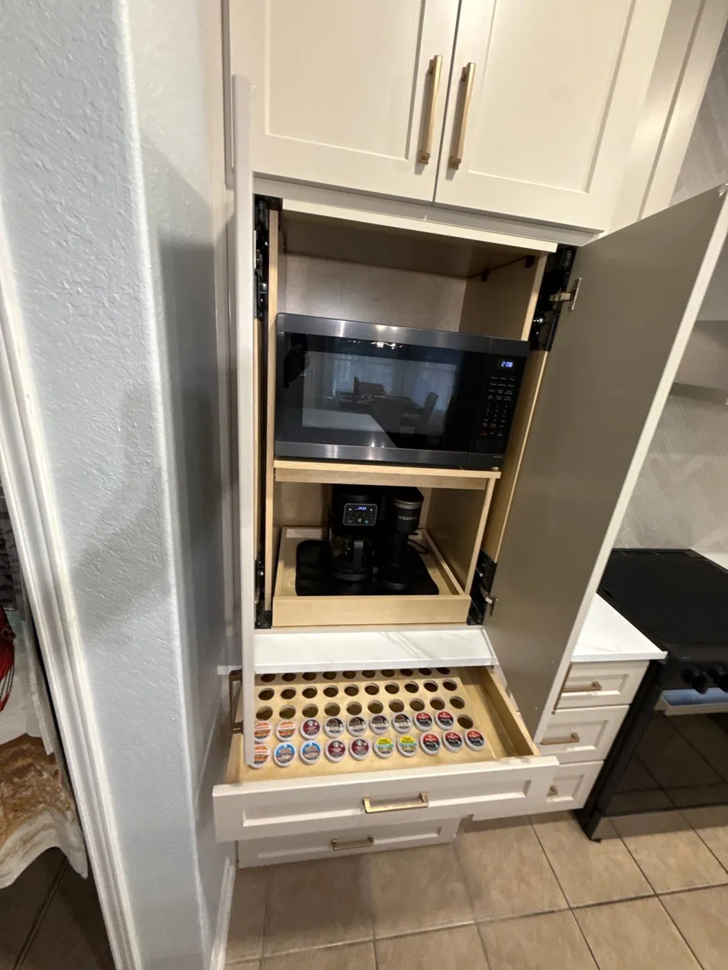 Appliance garage open, with the microwave and coffee station tucked inside