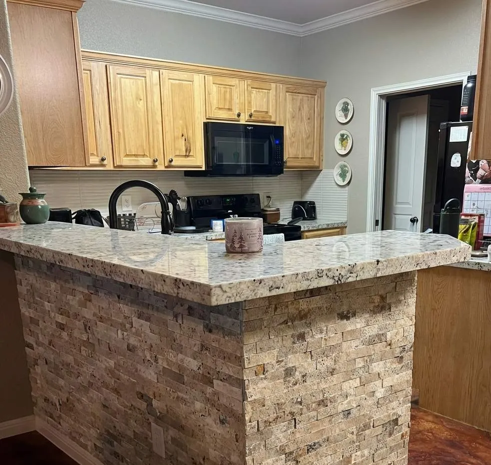 Breakfast bar with a stacked-stone face and new countertop